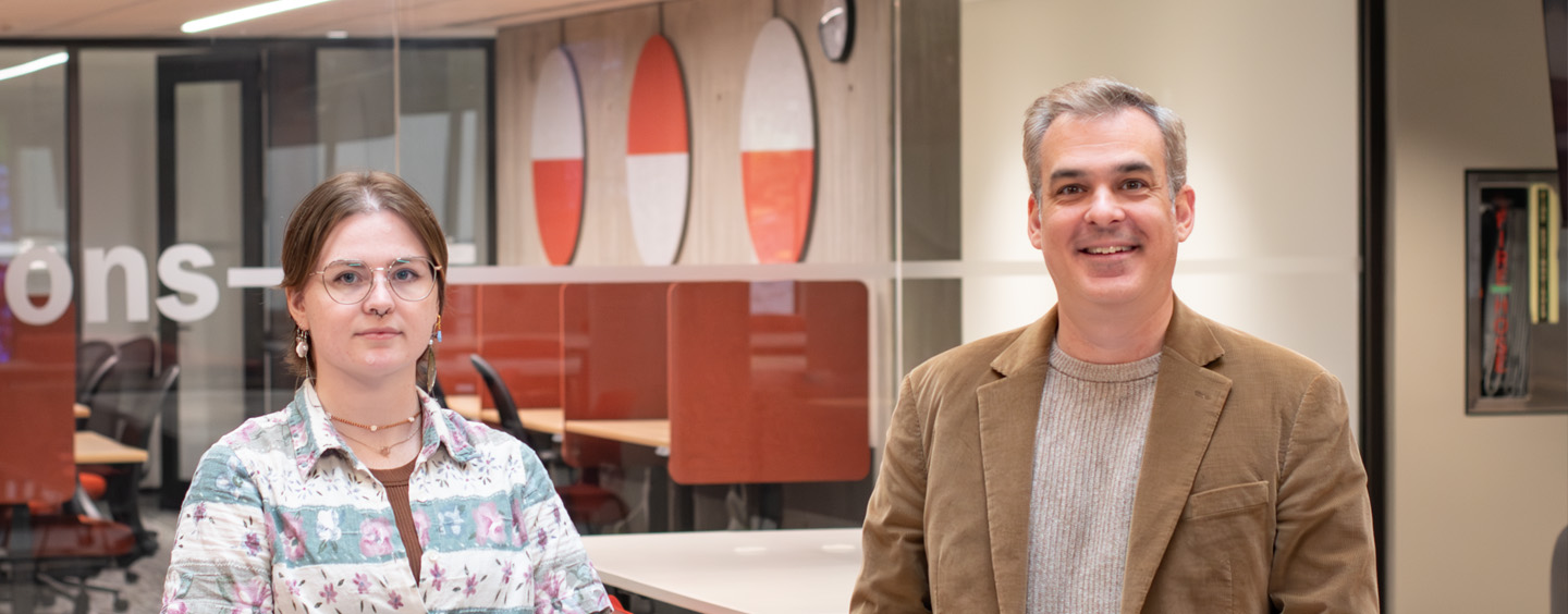 Image of Madison and Dr. Tim Compeau standing in the Digital Scholarship Centre at Weldon Library