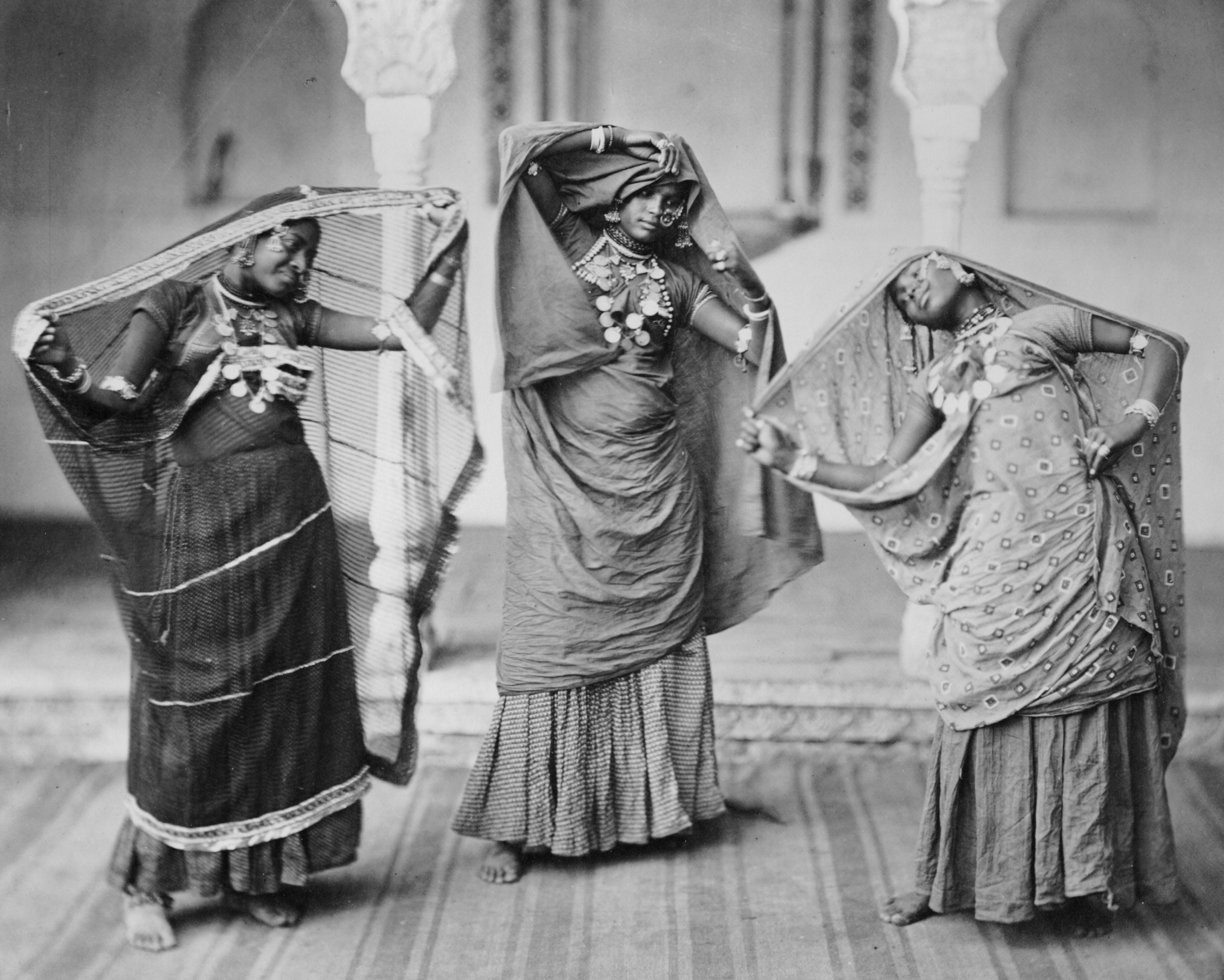 A photograph of three nautch dancers performing together