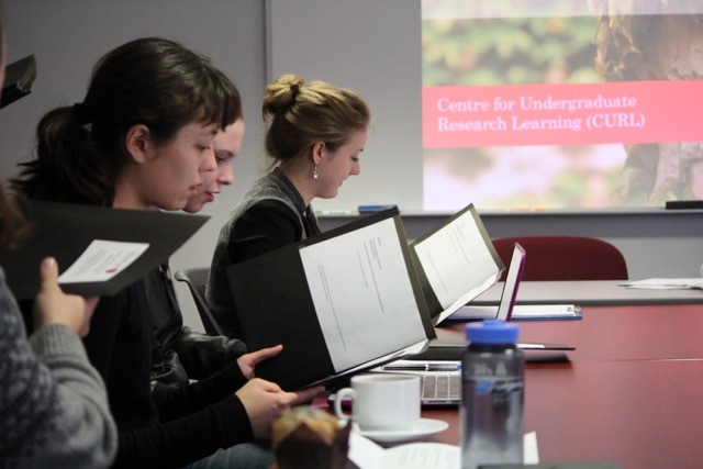 students reviewing notes at a table