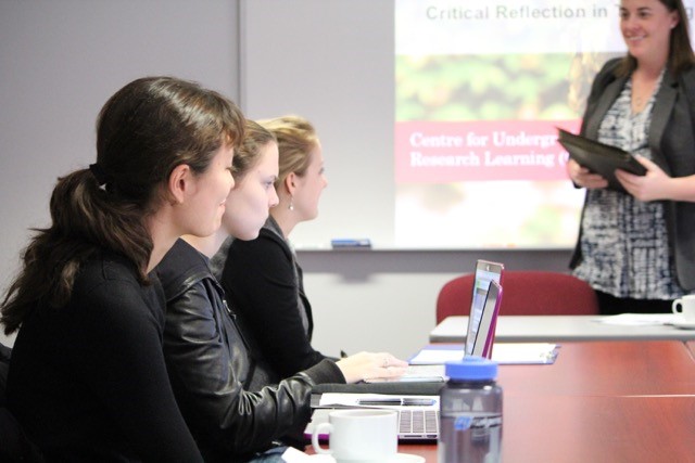 3 female students talking to workshop facilitator