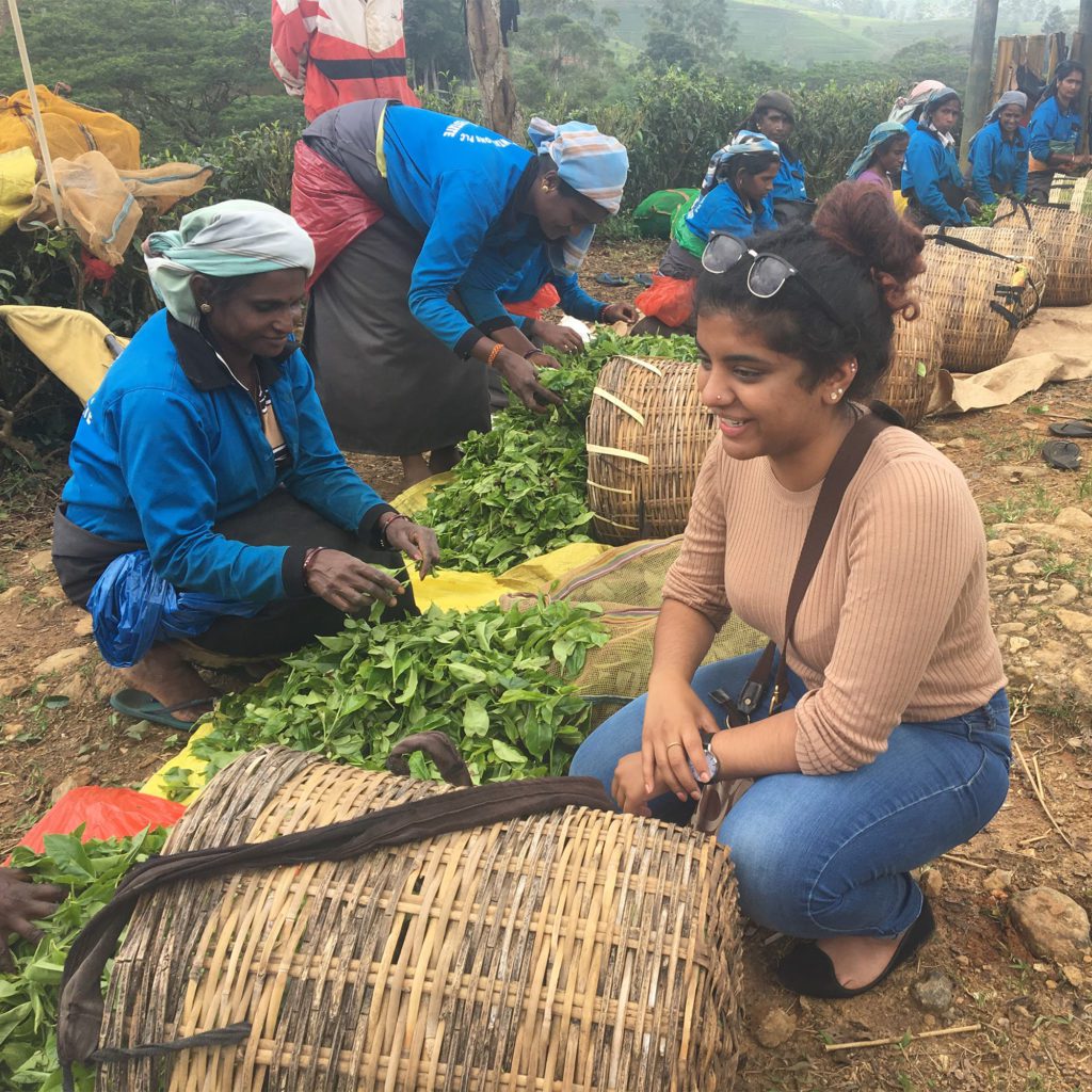 Huron student Valentina Gnanapragasam sits near Sri Lankan plantation workers. Her CURL Travel Bursary helped her volunteer there with Uniterra.