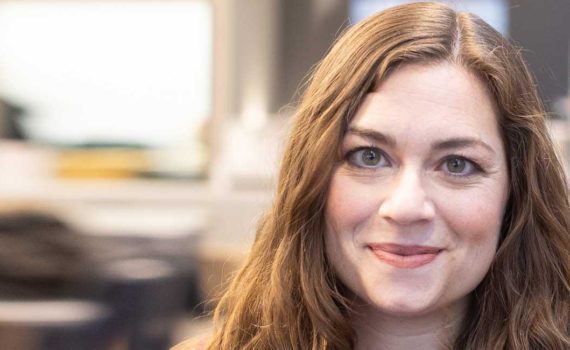 A photo of Amanda Di Ponio's smiling face. She has light skin and long, strawberry blonde hair.