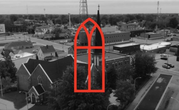 A greyscale photo of Christ Church in Chatham, as viewed from above and in front, with a red graphic of a church window over top.