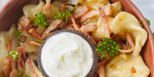 Pierogies in a bowl with sour cream
