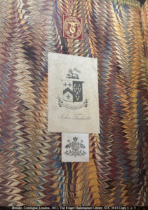 Three bookplates on red, yellow, blue, black and white marbled pastedown