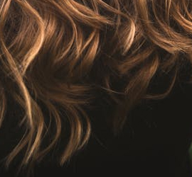 Image of dirty blonde hair on a black background