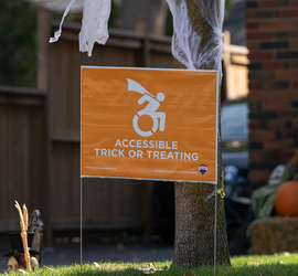 A "treat accessibly" sign on a lawn.